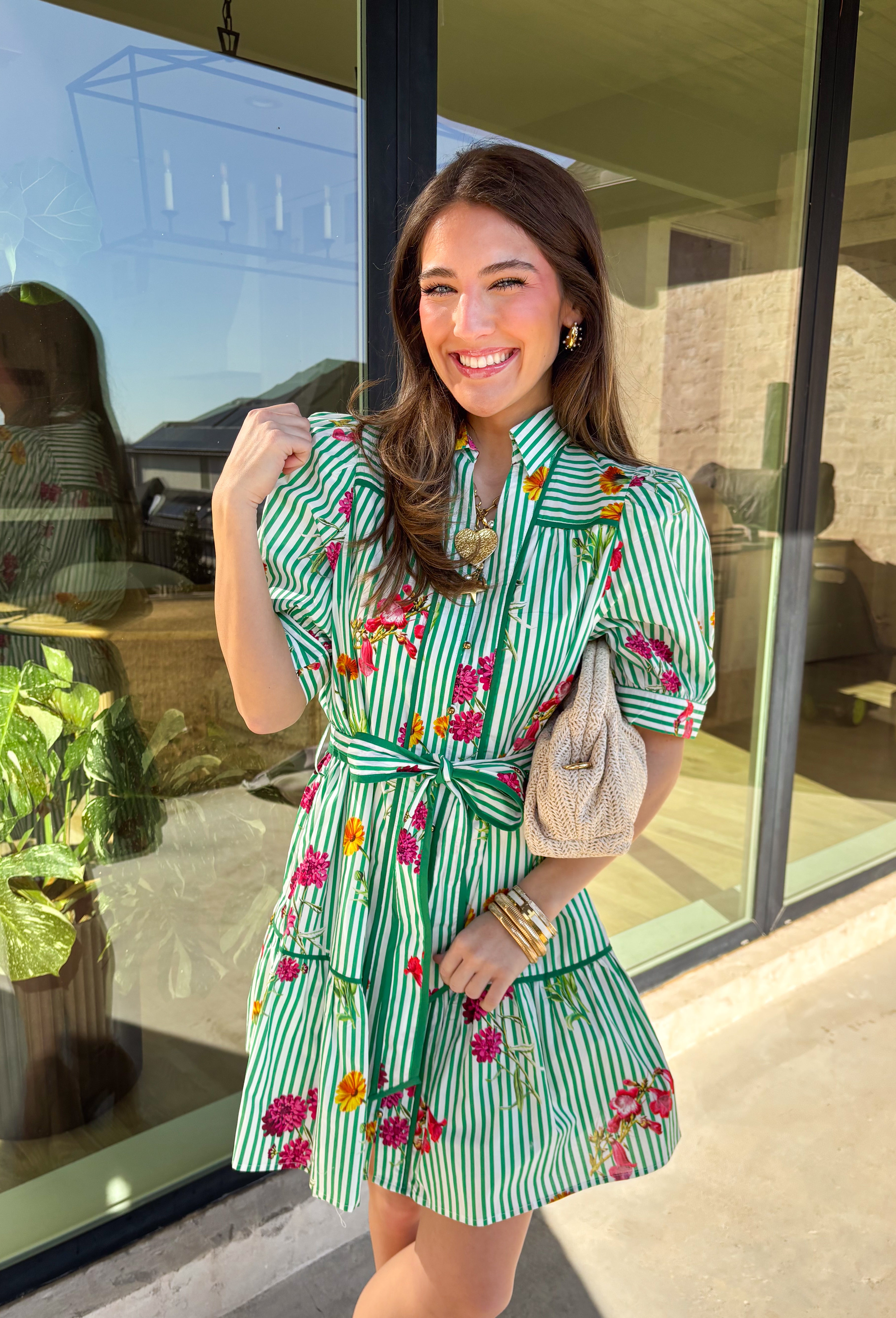 This green and white striped dress is spring sunshine in outfit form. Featuring a colorful floral print with pops of yellow, orange, pink, and purple, it’s the perfect mix of classic and cheerful. The collared neckline and gold button-down front give it a polished touch, while the matching self-tie belt cinches the waist for a flattering, adjustable fit. Fully lined and made from breathable cotton, this dress is ready for brunch dates, spring events, and every sunny-day plan in between.