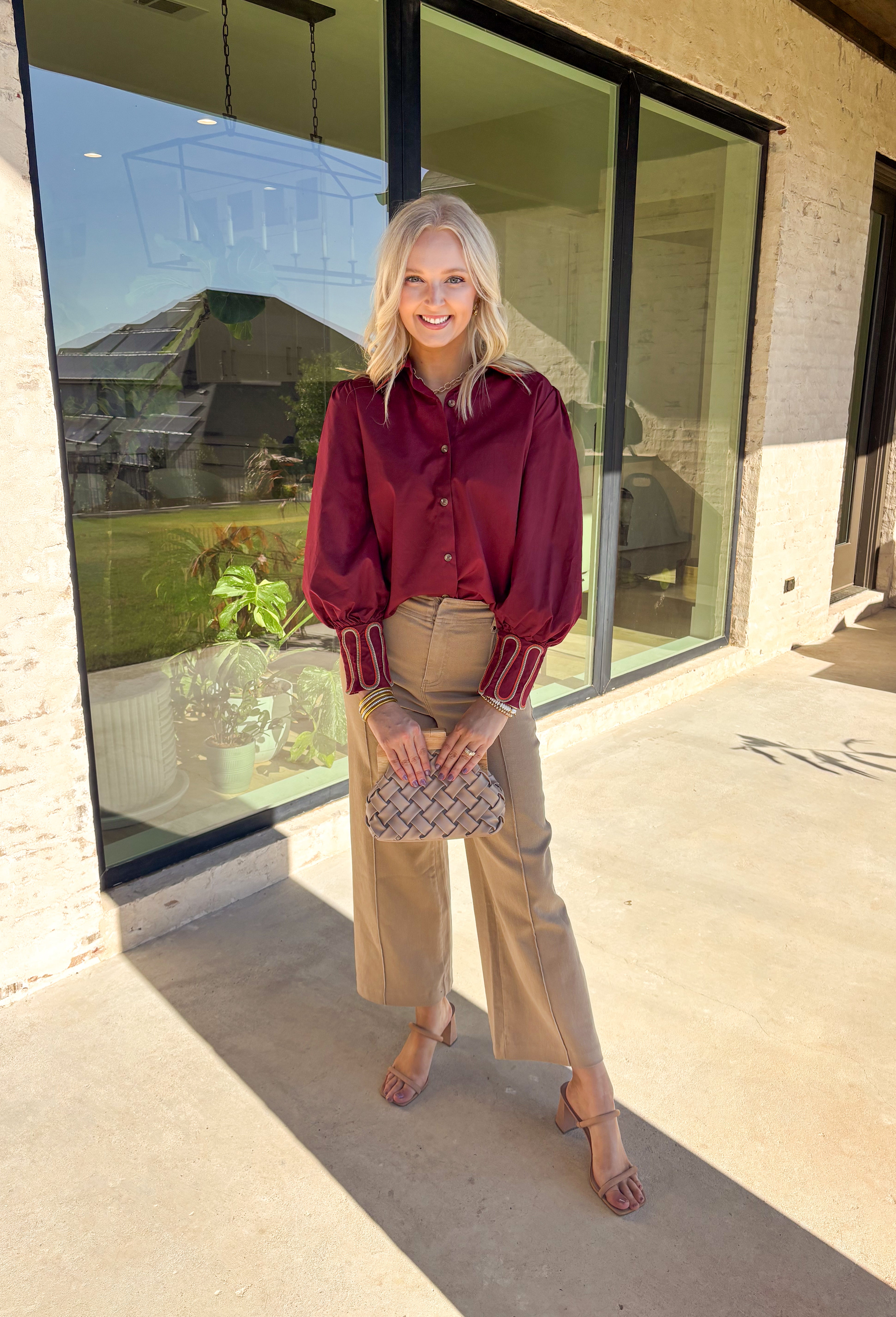 This burgundy button-down top by Jodifl brings unique embroidered detailing to a classic silhouette. The collar features intricate embroidery in olive, rust, and tan, while the sleeves showcase a coordinating abstract embroidered design in the same earthy tones—adding contrast and personality to the look. Crafted from 100% cotton, it’s breathable, lightweight, and perfect for styling through the season.