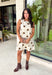 Classic polka dots never go out of style, and this charming dress from Day + Moon is the perfect blend of timeless style and feminine details. Designed with a soft cream backdrop and a rich brown polka dot print, this sleeveless dress is effortlessly chic for any occasion. The brown tie details at the top add a sweet, eye-catching touch, while the back zipper closure creates a flattering fit. 