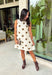 Classic polka dots never go out of style, and this charming dress from Day + Moon is the perfect blend of timeless style and feminine details. Designed with a soft cream backdrop and a rich brown polka dot print, this sleeveless dress is effortlessly chic for any occasion. The brown tie details at the top add a sweet, eye-catching touch, while the back zipper closure creates a flattering fit. 