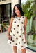 Classic polka dots never go out of style, and this charming dress from Day + Moon is the perfect blend of timeless style and feminine details. Designed with a soft cream backdrop and a rich brown polka dot print, this sleeveless dress is effortlessly chic for any occasion. The brown tie details at the top add a sweet, eye-catching touch, while the back zipper closure creates a flattering fit. 