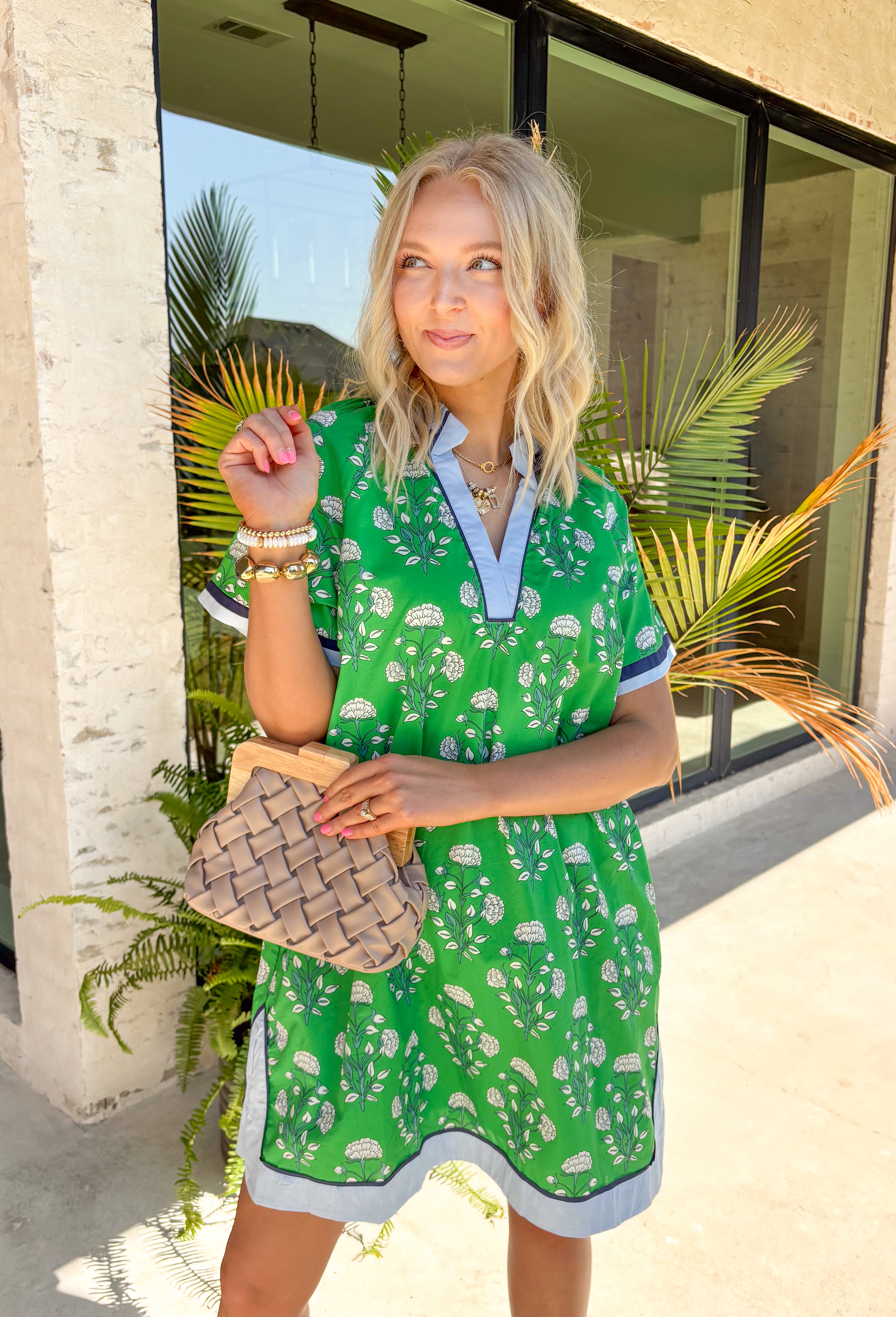This green floral dress is such a fresh and fun pick for summer! The white floral print keeps it light and easy, while the navy and baby blue trim adds the perfect pop of contrast that makes this one stand out. The short sleeves and breathable cotton fabric keep it comfortable for warm days, and the fully lined design makes it an easy grab-and-go option. Whether you're heading to brunch, church, or a weekend outing, this dress makes getting ready feel effortless. 