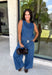 Double denim has never been easier with this matching two-piece set from Tres Bien. The sleeveless medium wash denim top features contrasting tan stitching throughout, giving the classic denim look a little extra detail. Coordinating wide leg jeans complete the set with an easy, relaxed silhouette, while the elastic waistband and adjustable self-tie detail keep the fit comfortable throughout the day. 