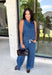 Double denim has never been easier with this matching two-piece set from Tres Bien. The sleeveless medium wash denim top features contrasting tan stitching throughout, giving the classic denim look a little extra detail. Coordinating wide leg jeans complete the set with an easy, relaxed silhouette, while the elastic waistband and adjustable self-tie detail keep the fit comfortable throughout the day. 