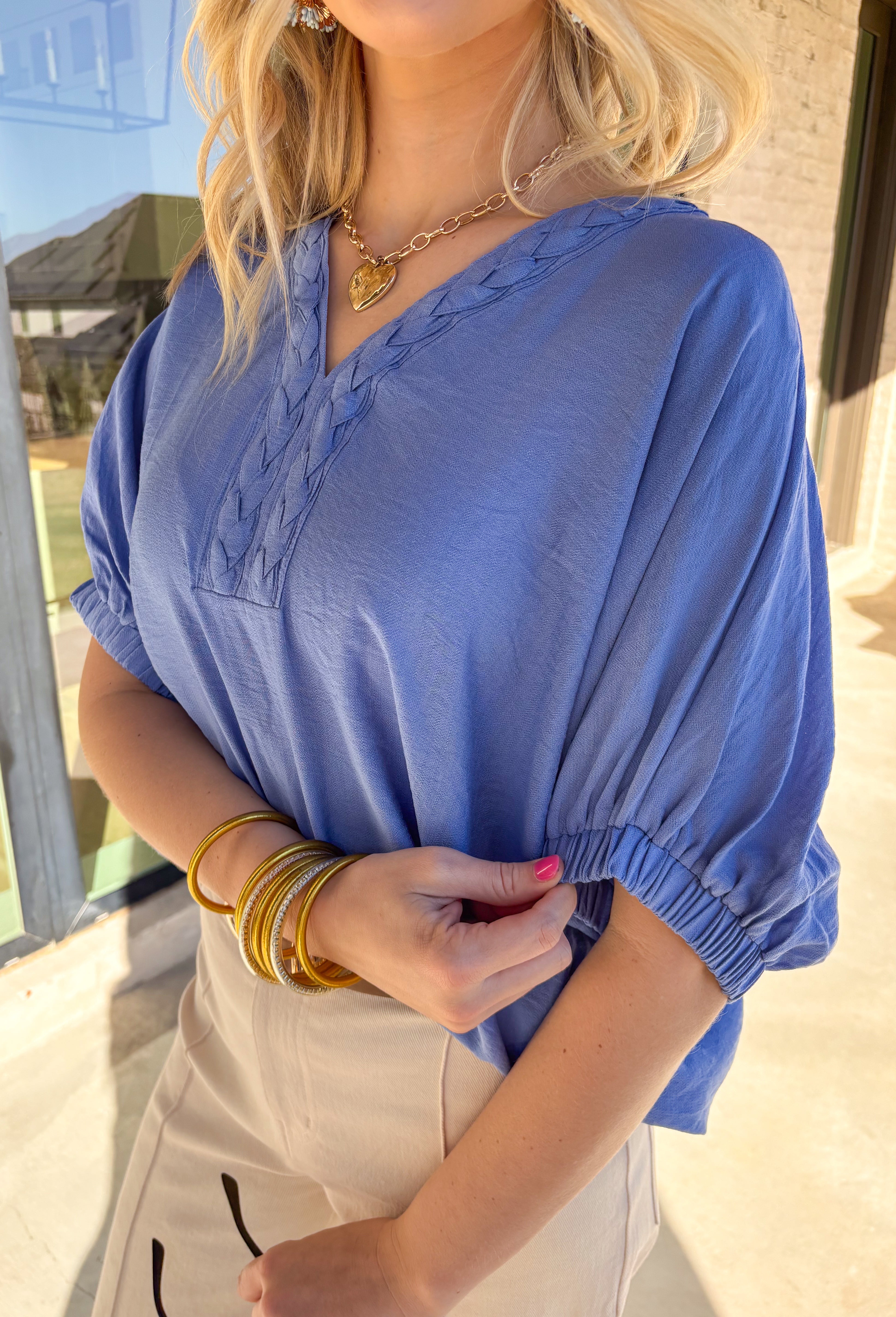 Soft, breezy, and effortlessly polished, this chambray dolman top by Entro is the perfect spring go-to. The relaxed dolman silhouette gives it an easy, flowy fit, while the v-neck accent with trenza detailing adds a subtle touch of texture that elevates the whole look. Lightweight and breathable, it’s an effortless piece that works for everyday wear, from casual errands to lunch plans.