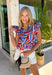 This colorful abstract print top is such a fun, statement-making piece for summer! Featuring a mix of red, white, blue, navy, and tan, it gives a subtle patriotic feel while still being easy to wear all season long. The ruffle sleeves and neckline add a soft, feminine touch, and the tie detail gives you that extra bit of styling versatility. Lightweight and breathable, it’s perfect for warm days when you want something a little elevated but still effortless. 