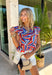 This colorful abstract print top is such a fun, statement-making piece for summer! Featuring a mix of red, white, blue, navy, and tan, it gives a subtle patriotic feel while still being easy to wear all season long. The ruffle sleeves and neckline add a soft, feminine touch, and the tie detail gives you that extra bit of styling versatility. Lightweight and breathable, it’s perfect for warm days when you want something a little elevated but still effortless. 