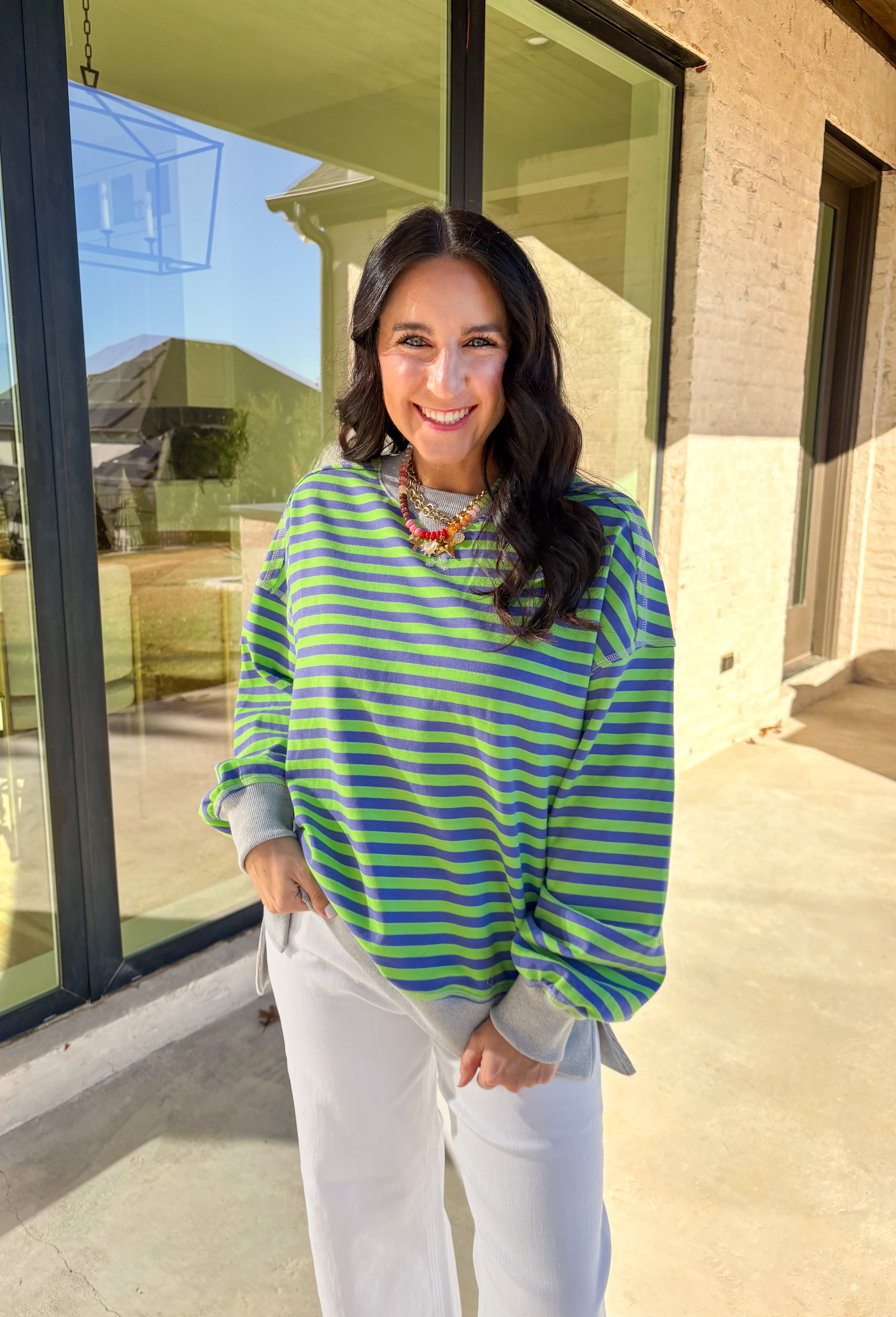 Bring a fresh pop of color to your spring wardrobe with this lightweight striped pullover by New In. The lime green and blue stripes add a cheerful touch, while the soft gray hem and cuffs give it a relaxed, casual finish. Perfect for breezy spring days, this comfy pullover pairs easily with denim or shorts for a laid-back, sunny-day look.