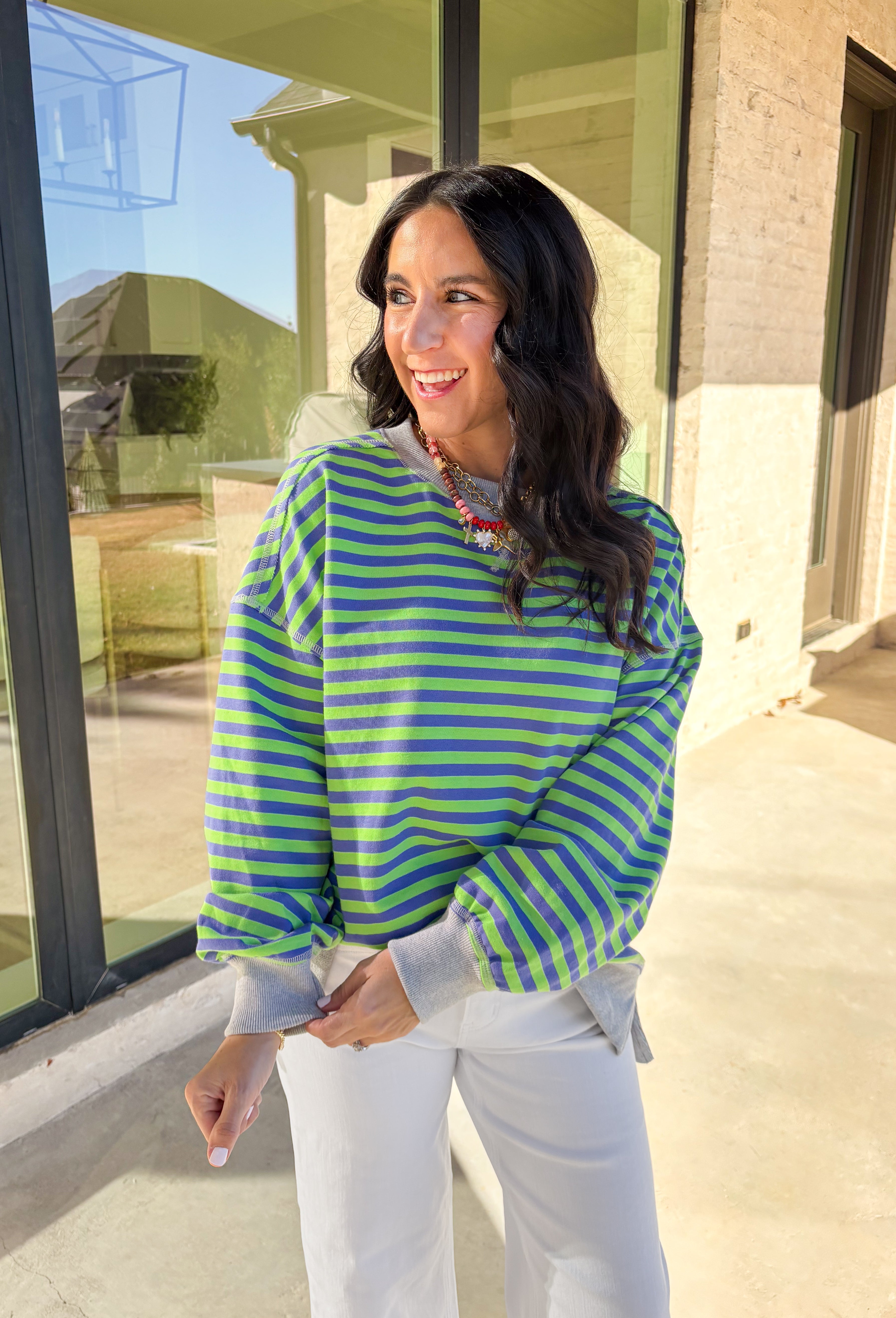 Bring a fresh pop of color to your spring wardrobe with this lightweight striped pullover by New In. The lime green and blue stripes add a cheerful touch, while the soft gray hem and cuffs give it a relaxed, casual finish. Perfect for breezy spring days, this comfy pullover pairs easily with denim or shorts for a laid-back, sunny-day look.