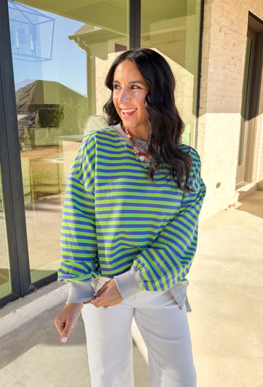 Bring a fresh pop of color to your spring wardrobe with this lightweight striped pullover by New In. The lime green and blue stripes add a cheerful touch, while the soft gray hem and cuffs give it a relaxed, casual finish. Perfect for breezy spring days, this comfy pullover pairs easily with denim or shorts for a laid-back, sunny-day look.
