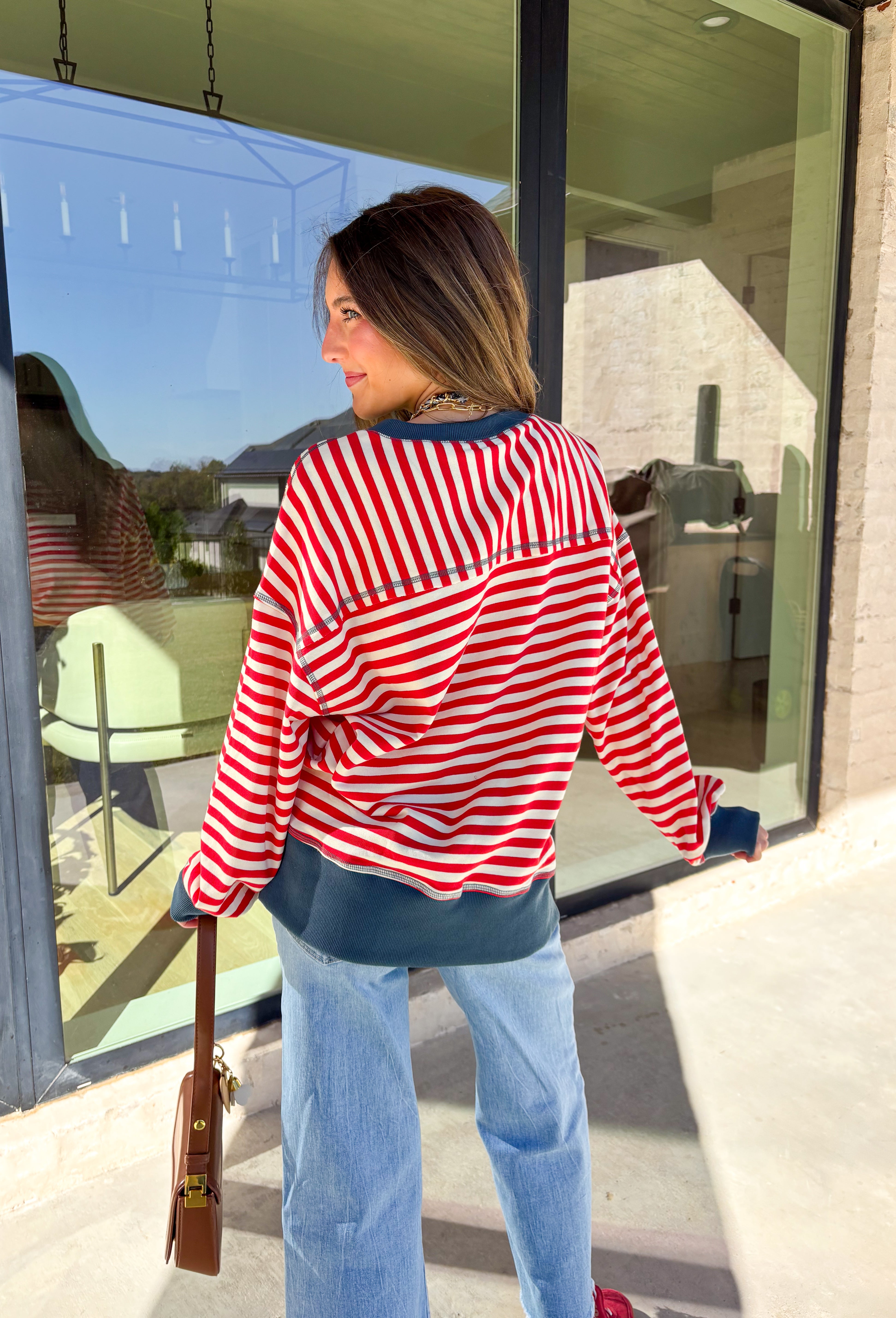 Stay cozy in classic stripes with this red and off-white pullover by New In. Designed with navy blue trim along the neckline, cuffs, and stitching, this lightweight knit brings a timeless touch to chilly days. Soft, comfortable, and easy to layer, it’s perfect for transitioning from crisp mornings to cozy evenings all winter long.