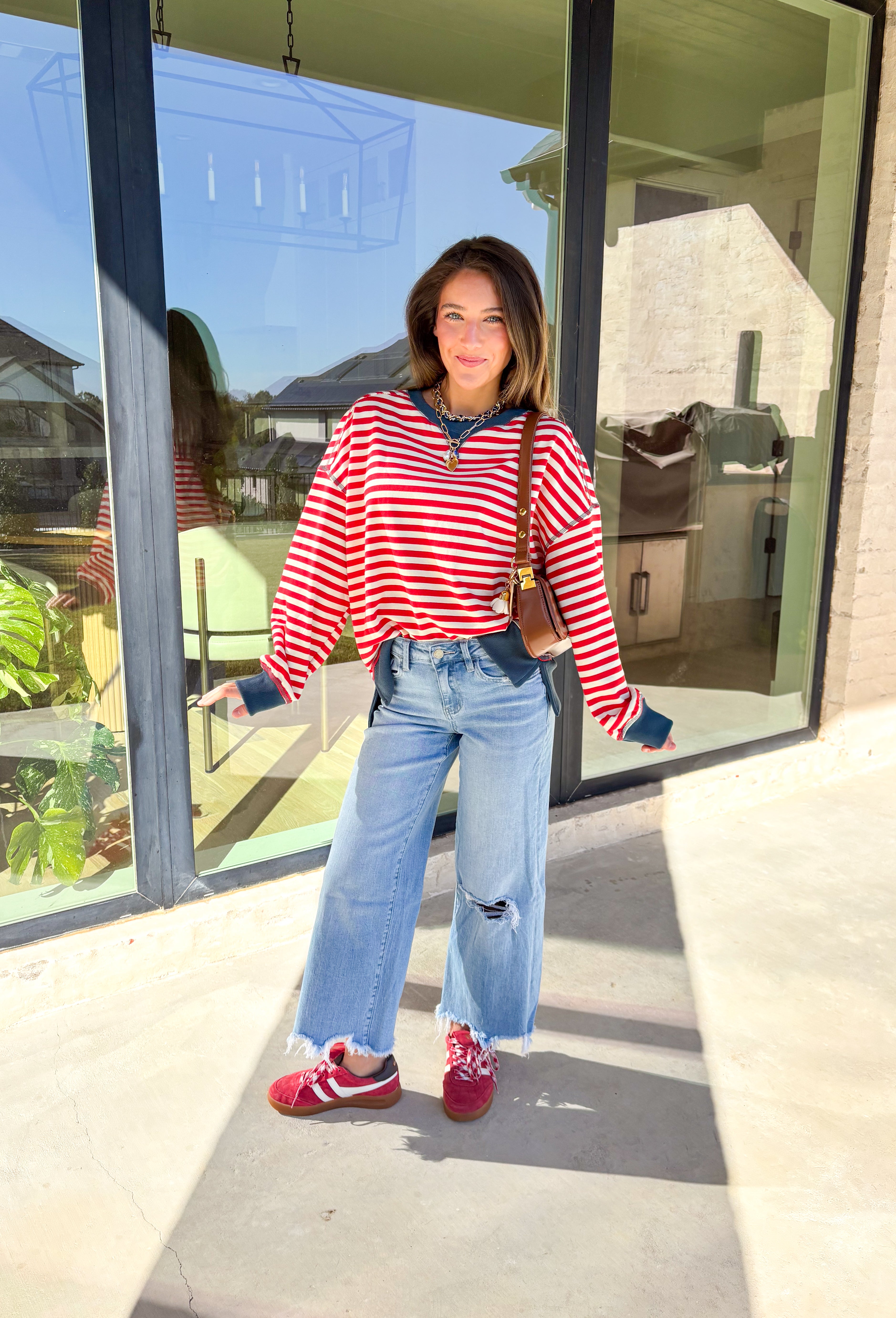 Stay cozy in classic stripes with this red and off-white pullover by New In. Designed with navy blue trim along the neckline, cuffs, and stitching, this lightweight knit brings a timeless touch to chilly days. Soft, comfortable, and easy to layer, it’s perfect for transitioning from crisp mornings to cozy evenings all winter long.