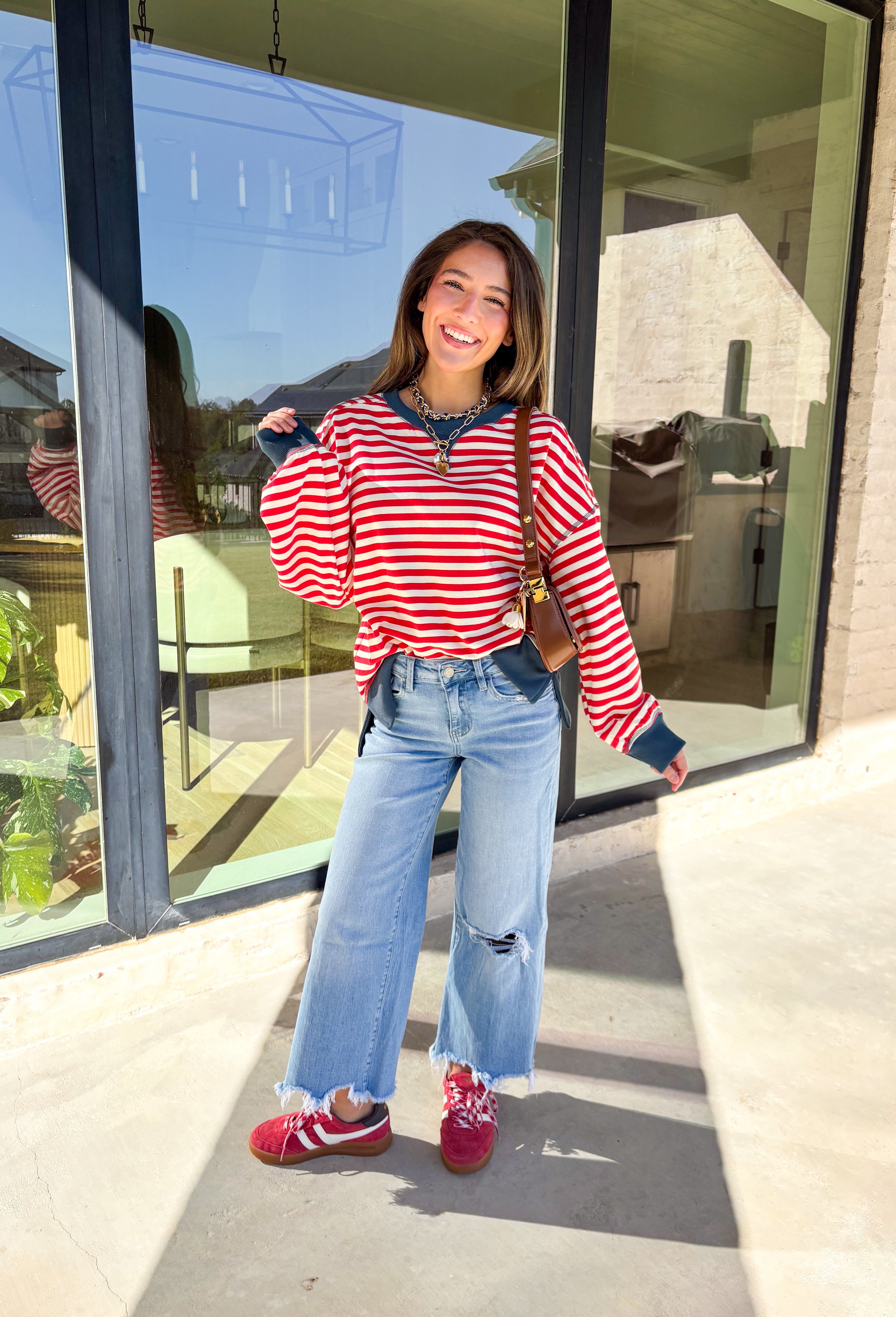 Stay cozy in classic stripes with this red and off-white pullover by New In. Designed with navy blue trim along the neckline, cuffs, and stitching, this lightweight knit brings a timeless touch to chilly days. Soft, comfortable, and easy to layer, it’s perfect for transitioning from crisp mornings to cozy evenings all winter long.