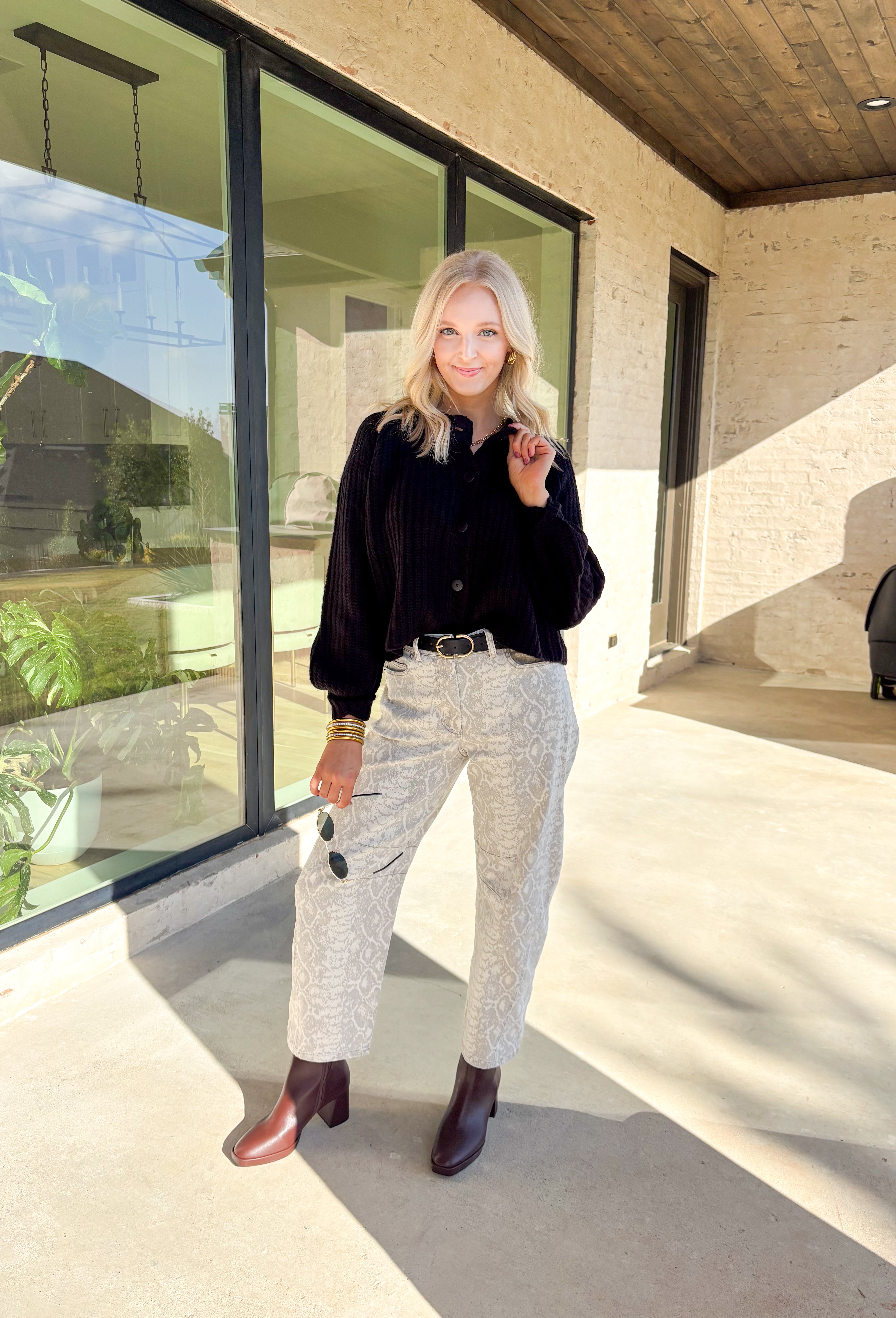 Keep it classic and cozy with this black knit button-down cardigan by Hyfve. The soft, medium-weight knit makes it perfect for layering through the seasons, while the timeless button-down design keeps it versatile for any occasion. Whether worn open over a tee or buttoned up with jeans, this cardigan is an easy go-to for effortless colder weather styling.