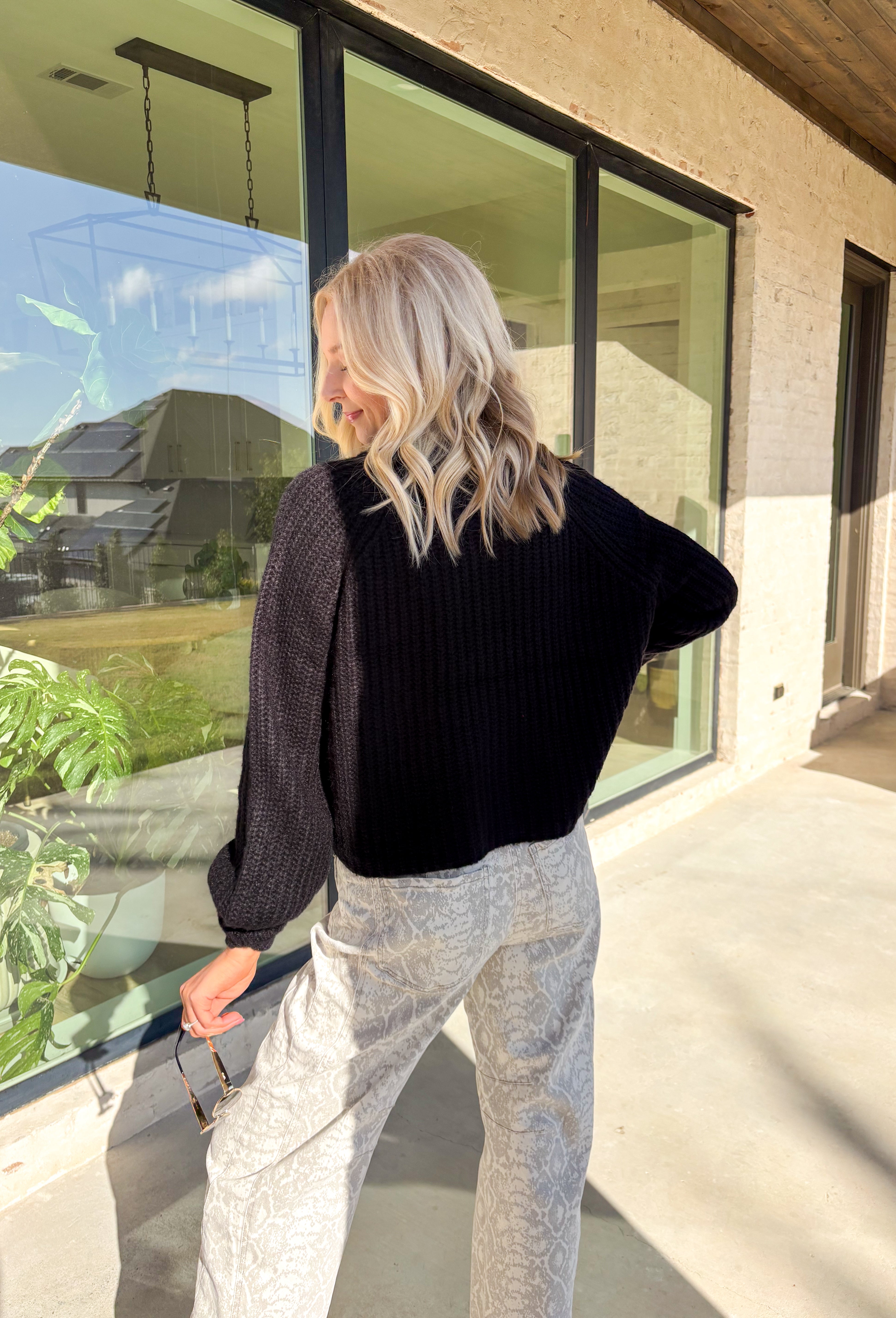 Keep it classic and cozy with this black knit button-down cardigan by Hyfve. The soft, medium-weight knit makes it perfect for layering through the seasons, while the timeless button-down design keeps it versatile for any occasion. Whether worn open over a tee or buttoned up with jeans, this cardigan is an easy go-to for effortless colder weather styling.