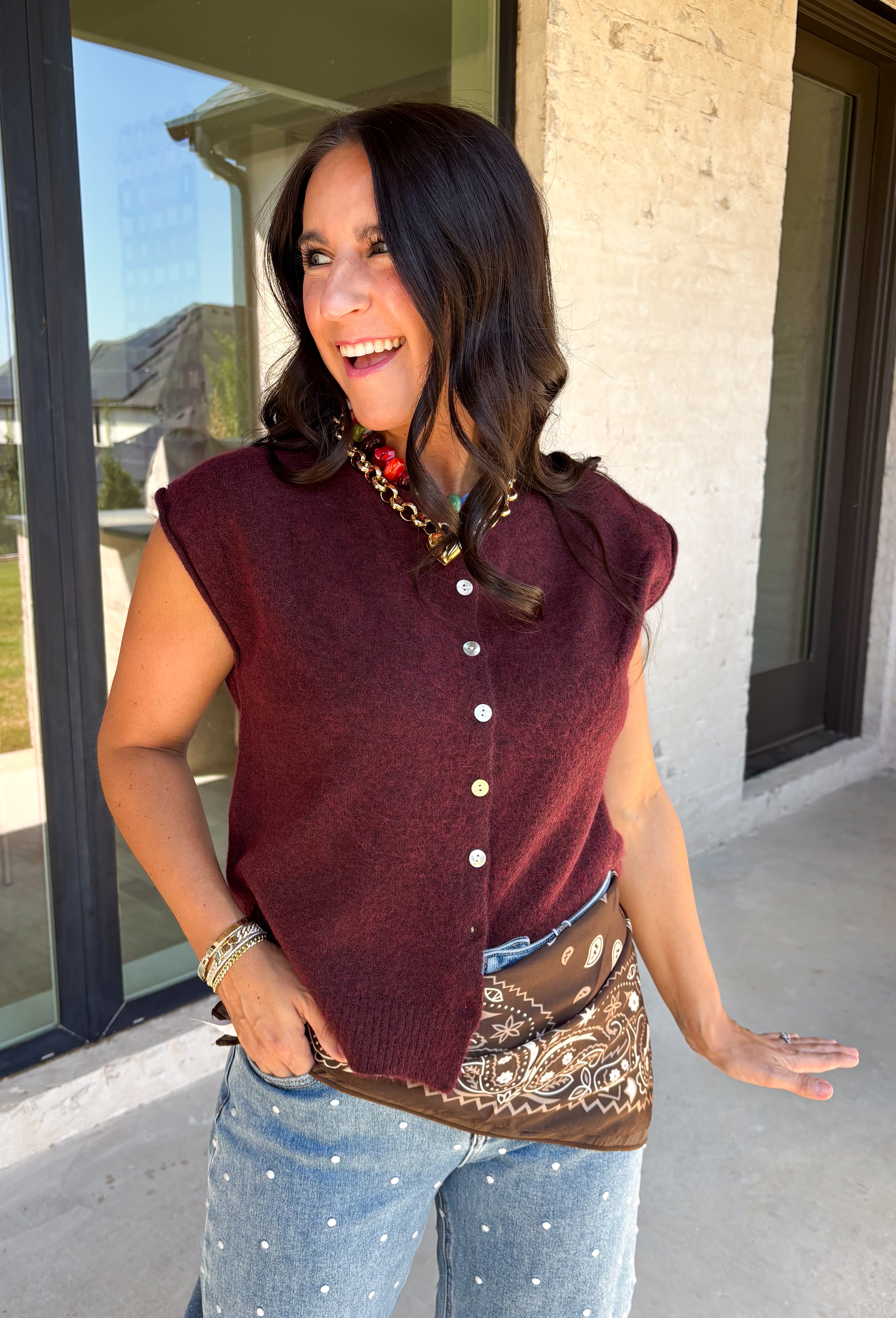 Layering season calls for pieces that can keep up with changing temperatures, and this dark cherry sleeveless cardigan from Double Zero is ready for just that. The cozy knit brings plenty of texture and warmth, while the sleeveless design makes it easy to wear alone on milder days or layer over a long sleeve top as winter gets closer. A button-down front gives you multiple ways to style it, and the ribbed hem adds a classic sweater finish. 