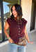 Layering season calls for pieces that can keep up with changing temperatures, and this dark cherry sleeveless cardigan from Double Zero is ready for just that. The cozy knit brings plenty of texture and warmth, while the sleeveless design makes it easy to wear alone on milder days or layer over a long sleeve top as winter gets closer. A button-down front gives you multiple ways to style it, and the ribbed hem adds a classic sweater finish. 