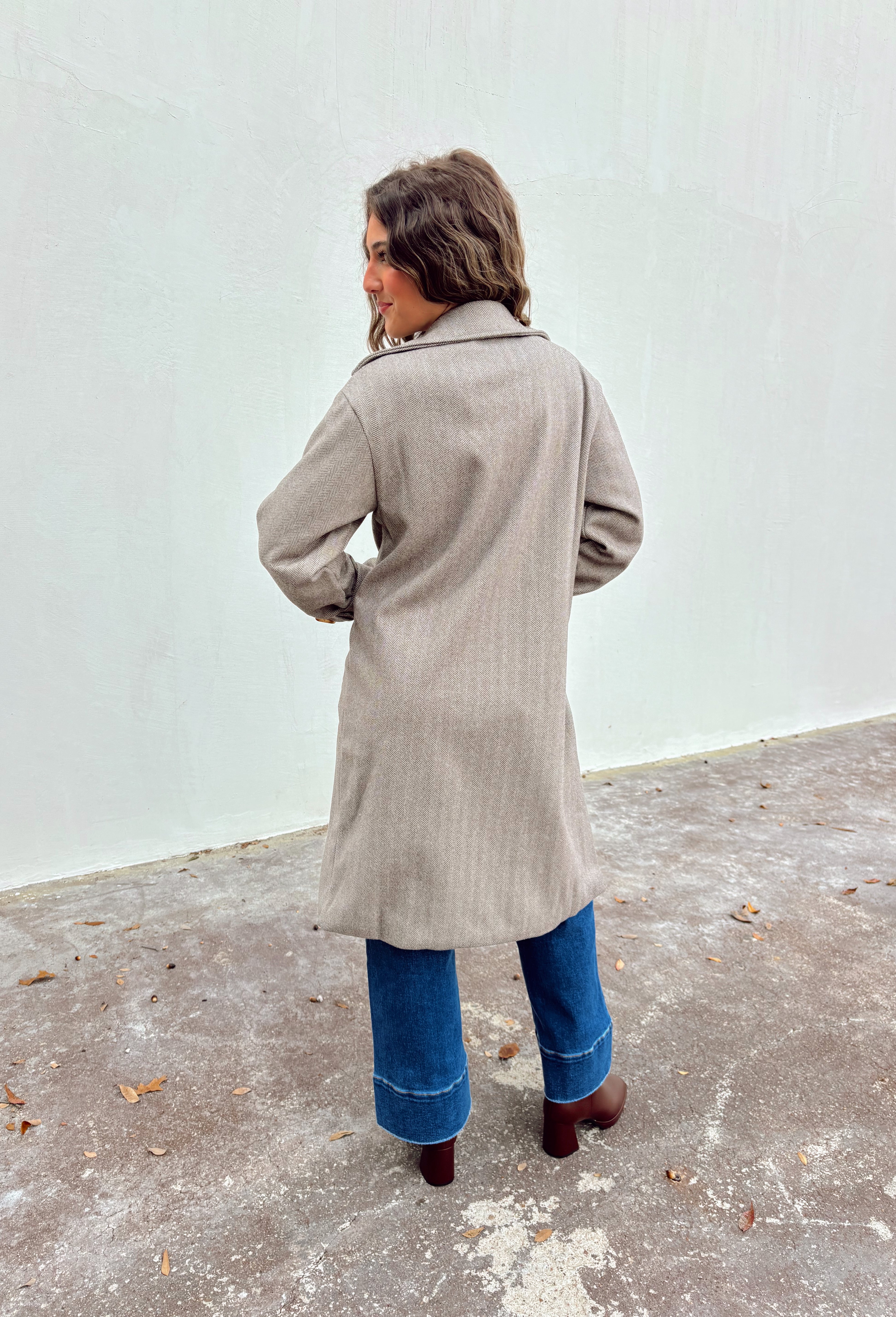 Timeless and tailored, this brown mini houndstooth coat by Haute Monde is a must-have for the chilly season. Featuring a collared neckline and button-down front, this soft and cozy coat brings effortless polish to any winter look. Its classic pattern and warm, textured feel make it a go-to piece for layering over sweaters, dresses, or denim all season long.