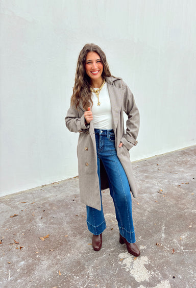 Timeless and tailored, this brown mini houndstooth coat by Haute Monde is a must-have for the chilly season. Featuring a collared neckline and button-down front, this soft and cozy coat brings effortless polish to any winter look. Its classic pattern and warm, textured feel make it a go-to piece for layering over sweaters, dresses, or denim all season long.