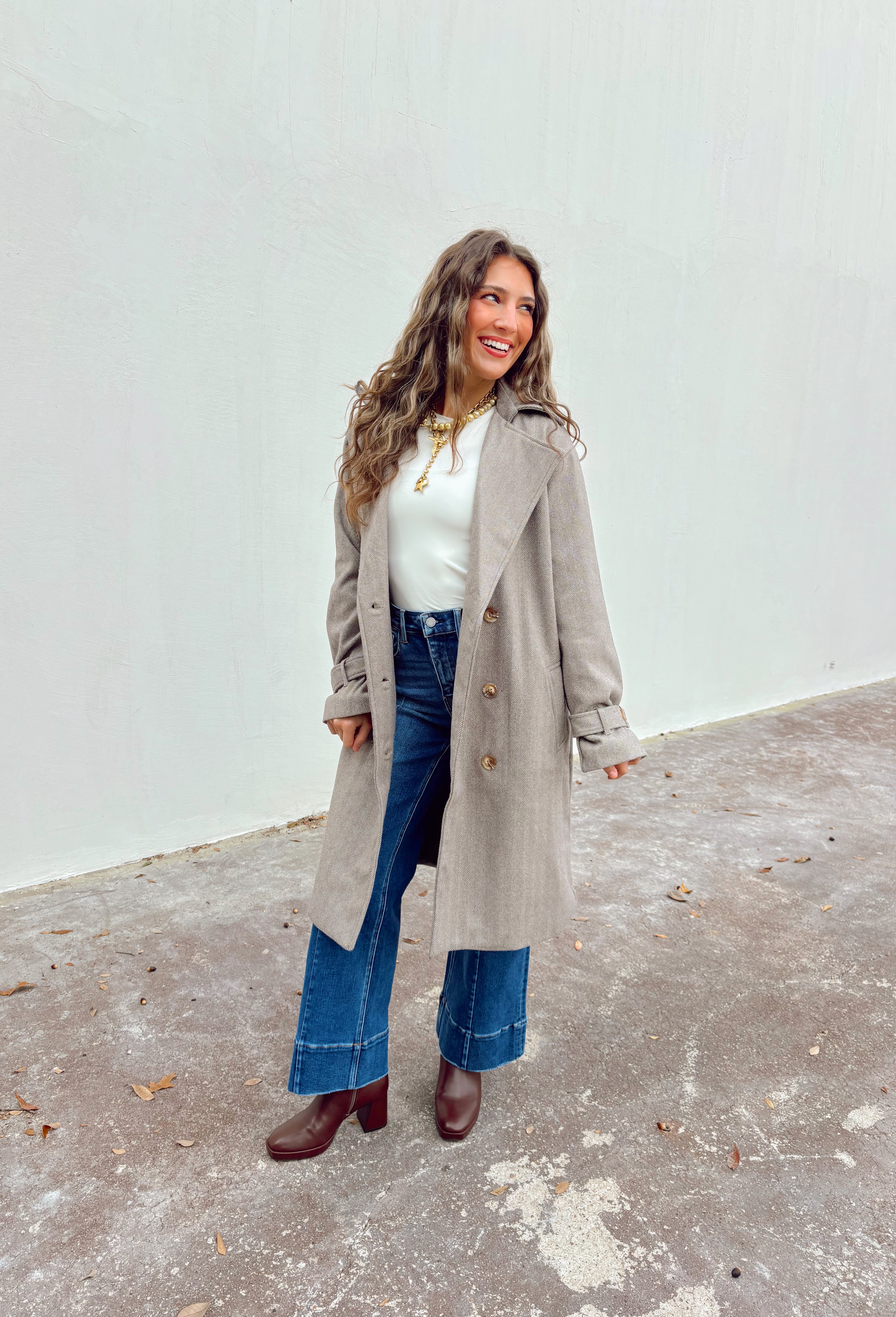 Timeless and tailored, this brown mini houndstooth coat by Haute Monde is a must-have for the chilly season. Featuring a collared neckline and button-down front, this soft and cozy coat brings effortless polish to any winter look. Its classic pattern and warm, textured feel make it a go-to piece for layering over sweaters, dresses, or denim all season long.