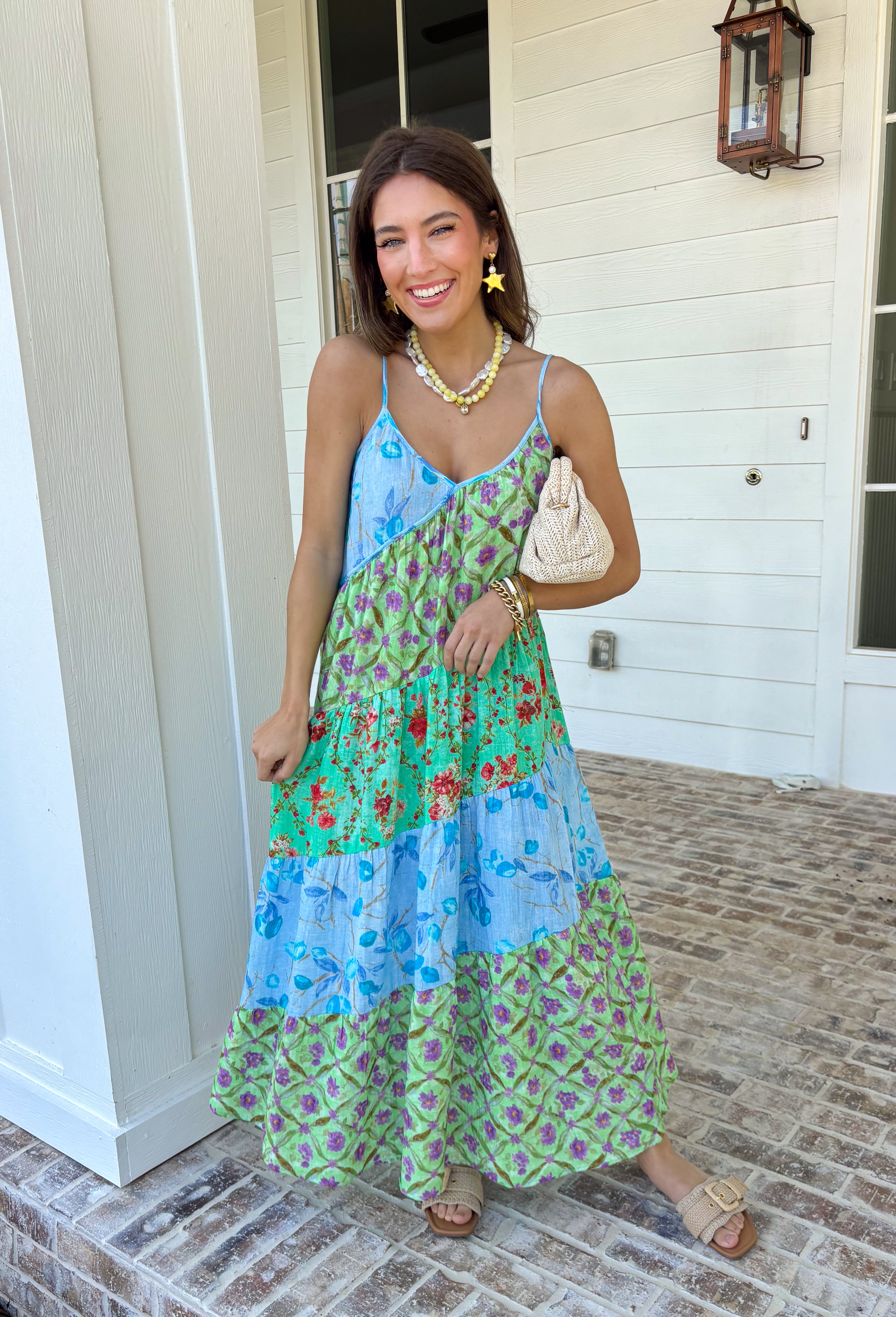 This tiered color block midi dress is made for sunshine-filled days and standout summer moments! Featuring a mix of green, purple, and blue with a floral print, it brings the perfect pop of color while still feeling easy and wearable. The tiered design gives it a flowy, flattering shape, and the adjustable straps with a v-neckline keep the fit comfortable and customizable. Lightweight in 100% cotton, it’s perfect for staying cool while looking put together.