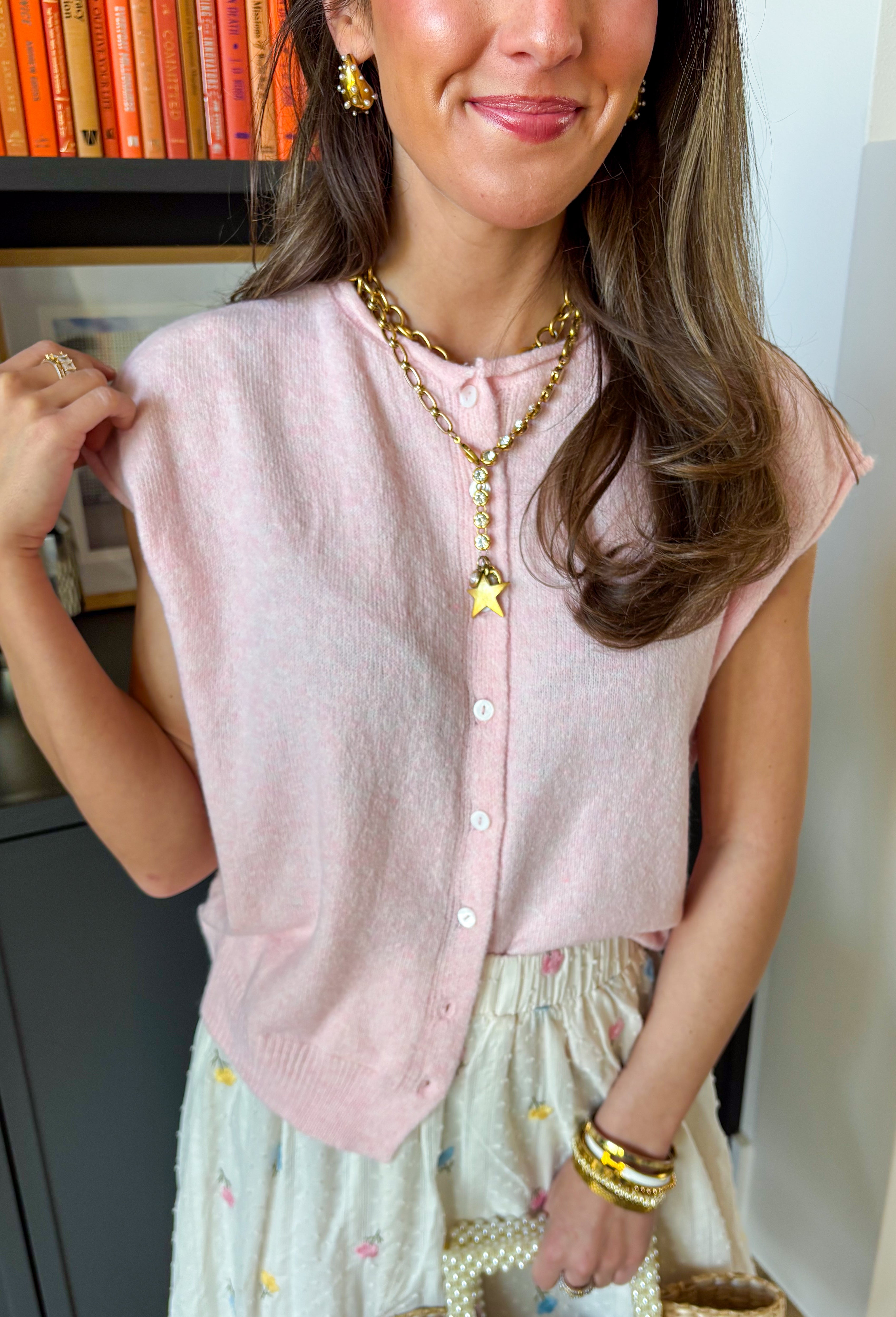 Soft, happy, and so easy to style — this light pink short sleeve button down sweater is the perfect lightweight layer for transitioning seasons. The cheerful hue instantly brightens your outfit, while the knit texture keeps it feeling polished yet relaxed. Designed with a classic button down front and short sleeves, this sweater works beautifully worn on its own or layered over a tank.