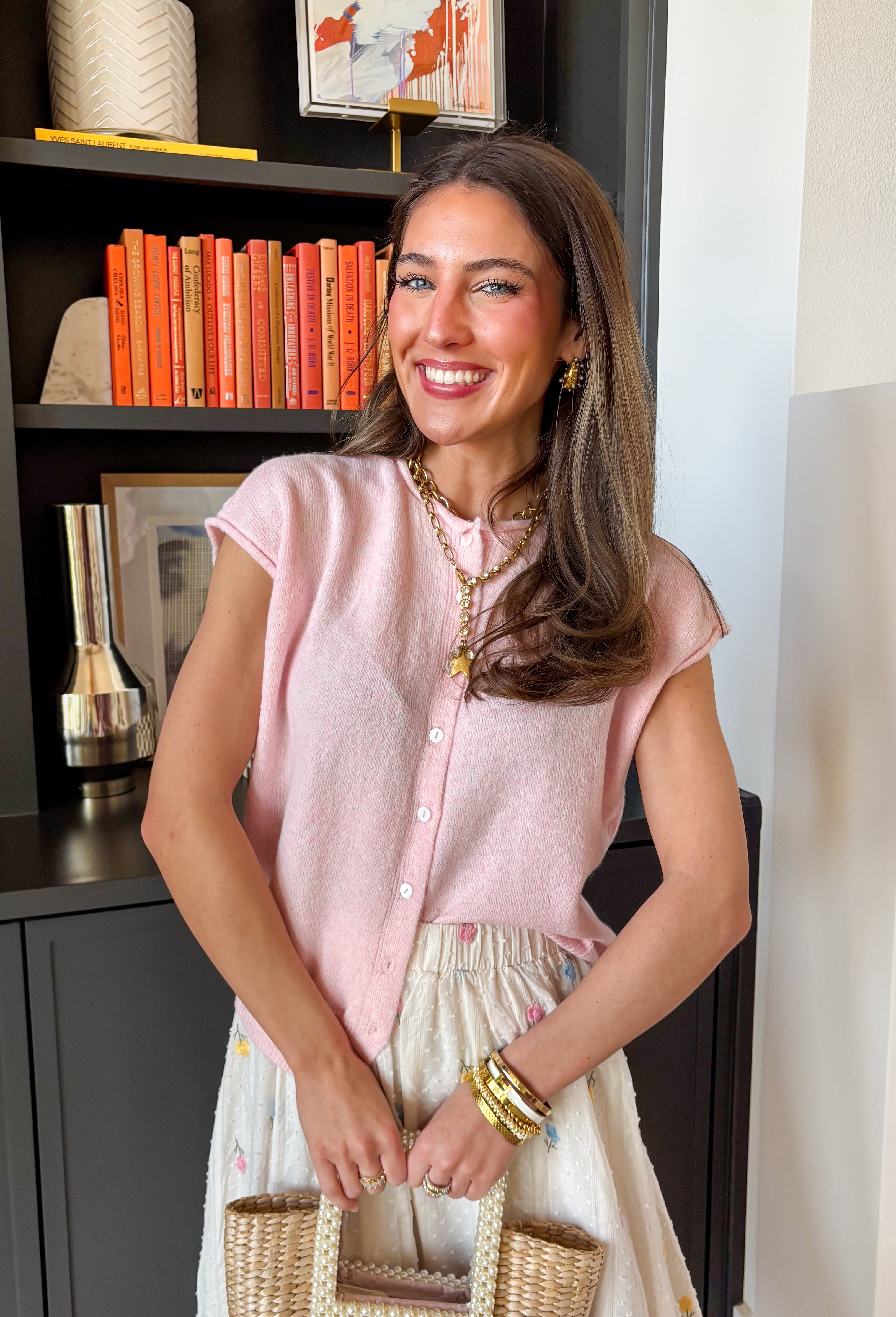 Soft, happy, and so easy to style — this light pink short sleeve button down sweater is the perfect lightweight layer for transitioning seasons. The cheerful hue instantly brightens your outfit, while the knit texture keeps it feeling polished yet relaxed. Designed with a classic button down front and short sleeves, this sweater works beautifully worn on its own or layered over a tank.