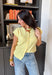 Soft, sunny, and so easy to style — this butter yellow short sleeve button down sweater is the perfect lightweight layer for transitioning seasons. The cheerful hue instantly brightens your outfit, while the knit texture keeps it feeling polished yet relaxed. Designed with a classic button down front and short sleeves, this sweater works beautifully worn on its own or layered over a tank.