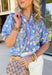Soft, dreamy, and made for sunny spring days — this faded blue top features a delicate washed floral print in peach, airy blues, and light purple tones that feel effortlessly fresh. The vintage-inspired finish gives it that perfectly worn-in charm while still feeling polished and feminine. Light purple scalloped trim runs along the front for the sweetest pop of contrast, while subtle smocking adds texture and flattering shape. 