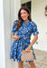Fresh, fun, and full of spring charm, this blue short sleeve button-down dress by Entro is an easy standout. Featuring a floral print throughout, it brings the perfect pop of color while still feeling effortless and wearable. Blue and white striped trim accents the design for a playful contrast, and the matching self-tie waist gives it a flattering, adjustable fit. Finished with side pockets and a fully lined cotton feel, this dress is perfect for brunch, spring events, and sunny weekends.