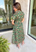 Brighten up your fall wardrobe with this dreamy green midi dress, splashed with warm shades of orange floral print. The collared neckline and button-down design add a touch of tailored charm, while the matching belt lets you cinch the waist for a flattering silhouette. Whether you're headed to brunch or a pumpkin patch date, this one’s got that perfect for all season long.