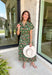 Brighten up your fall wardrobe with this dreamy green midi dress, splashed with warm shades of orange floral print. The collared neckline and button-down design add a touch of tailored charm, while the matching belt lets you cinch the waist for a flattering silhouette. Whether you're headed to brunch or a pumpkin patch date, this one’s got that perfect for all season long.