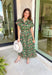 Brighten up your fall wardrobe with this dreamy green midi dress, splashed with warm shades of orange floral print. The collared neckline and button-down design add a touch of tailored charm, while the matching belt lets you cinch the waist for a flattering silhouette. Whether you're headed to brunch or a pumpkin patch date, this one’s got that perfect for all season long.