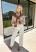 Get the polished look of layering without any extra effort in this chic top from Hyfve. Designed with a classic camel and white striped button-down base, this unique piece features a camel ribbed sweater overlay for a perfectly styled layered look in one easy top. The collared neckline and front pocket add timeless appeal, while the lightweight fabric keeps it comfortable for all-day wear. 