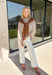 Get the polished look of layering without any extra effort in this chic top from Hyfve. Designed with a classic camel and white striped button-down base, this unique piece features a camel ribbed sweater overlay for a perfectly styled layered look in one easy top. The collared neckline and front pocket add timeless appeal, while the lightweight fabric keeps it comfortable for all-day wear. 