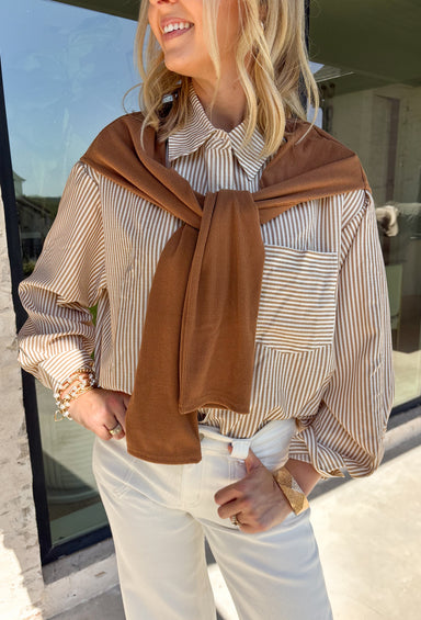Get the polished look of layering without any extra effort in this chic top from Hyfve. Designed with a classic camel and white striped button-down base, this unique piece features a camel ribbed sweater overlay for a perfectly styled layered look in one easy top. The collared neckline and front pocket add timeless appeal, while the lightweight fabric keeps it comfortable for all-day wear. 