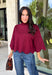 Rich merlot color makes this sweater top from Entro an instant favorite for the cooler months. The deep wine-inspired shade adds the perfect pop of seasonal color while still pairing easily with denim, cream, camel, and other autumn neutrals. A mock neckline gives it a classic look, while scalloped edges along the hem and sleeves add a sweet, unexpected finish. The ¾ length sleeves make it an easy transitional piece for warmer fall afternoons and chilly days ahead. 