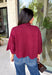 Rich merlot color makes this sweater top from Entro an instant favorite for the cooler months. The deep wine-inspired shade adds the perfect pop of seasonal color while still pairing easily with denim, cream, camel, and other autumn neutrals. A mock neckline gives it a classic look, while scalloped edges along the hem and sleeves add a sweet, unexpected finish. The ¾ length sleeves make it an easy transitional piece for warmer fall afternoons and chilly days ahead. 