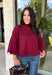 Rich merlot color makes this sweater top from Entro an instant favorite for the cooler months. The deep wine-inspired shade adds the perfect pop of seasonal color while still pairing easily with denim, cream, camel, and other autumn neutrals. A mock neckline gives it a classic look, while scalloped edges along the hem and sleeves add a sweet, unexpected finish. The ¾ length sleeves make it an easy transitional piece for warmer fall afternoons and chilly days ahead. 