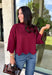 Rich merlot color makes this sweater top from Entro an instant favorite for the cooler months. The deep wine-inspired shade adds the perfect pop of seasonal color while still pairing easily with denim, cream, camel, and other autumn neutrals. A mock neckline gives it a classic look, while scalloped edges along the hem and sleeves add a sweet, unexpected finish. The ¾ length sleeves make it an easy transitional piece for warmer fall afternoons and chilly days ahead. 