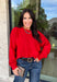Nothing says cozy season like a classic red sweater, and this timeless knit from Double Zero is one you'll reach for again and again. Designed in a rich red hue, this effortlessly versatile sweater features exposed seam detailing that adds a modern touch to its classic silhouette. Ribbed trim at the neckline and cuffs provides a polished finish, while the soft knit construction keeps you warm and comfortable all day long. 
