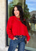 Nothing says cozy season like a classic red sweater, and this timeless knit from Double Zero is one you'll reach for again and again. Designed in a rich red hue, this effortlessly versatile sweater features exposed seam detailing that adds a modern touch to its classic silhouette. Ribbed trim at the neckline and cuffs provides a polished finish, while the soft knit construction keeps you warm and comfortable all day long. 