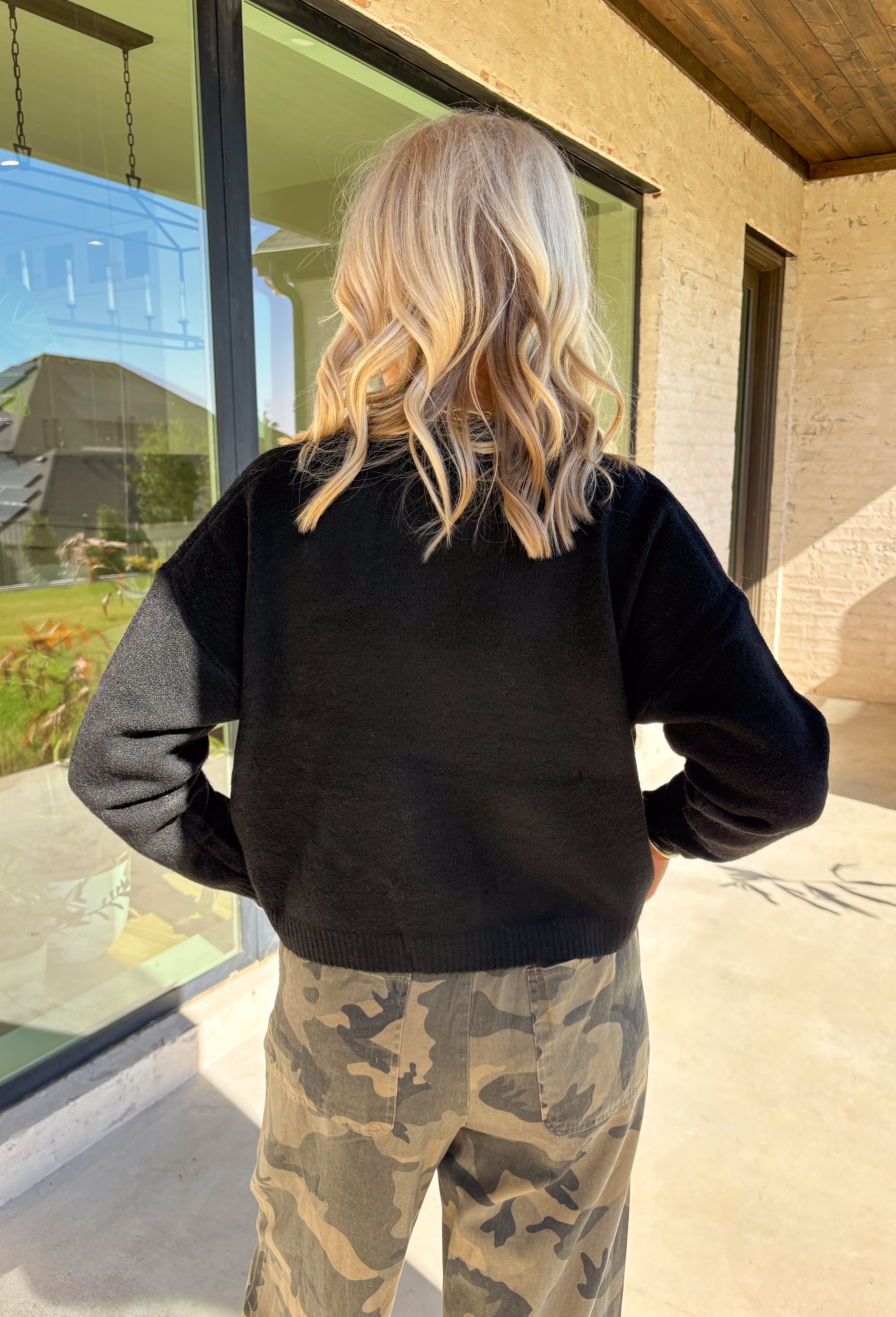 A cardigan with character—this black knit sweater is anything but ordinary. Designed with a button-down front, it’s accented with two charming ducks on the front that bring a whimsical, playful twist to your fall wardrobe. The soft knit blend offers warmth and comfort, while the relaxed fit makes it perfect for layering over everything from tees to dresses. A fun conversation starter that still feels cozy enough for everyday wear.