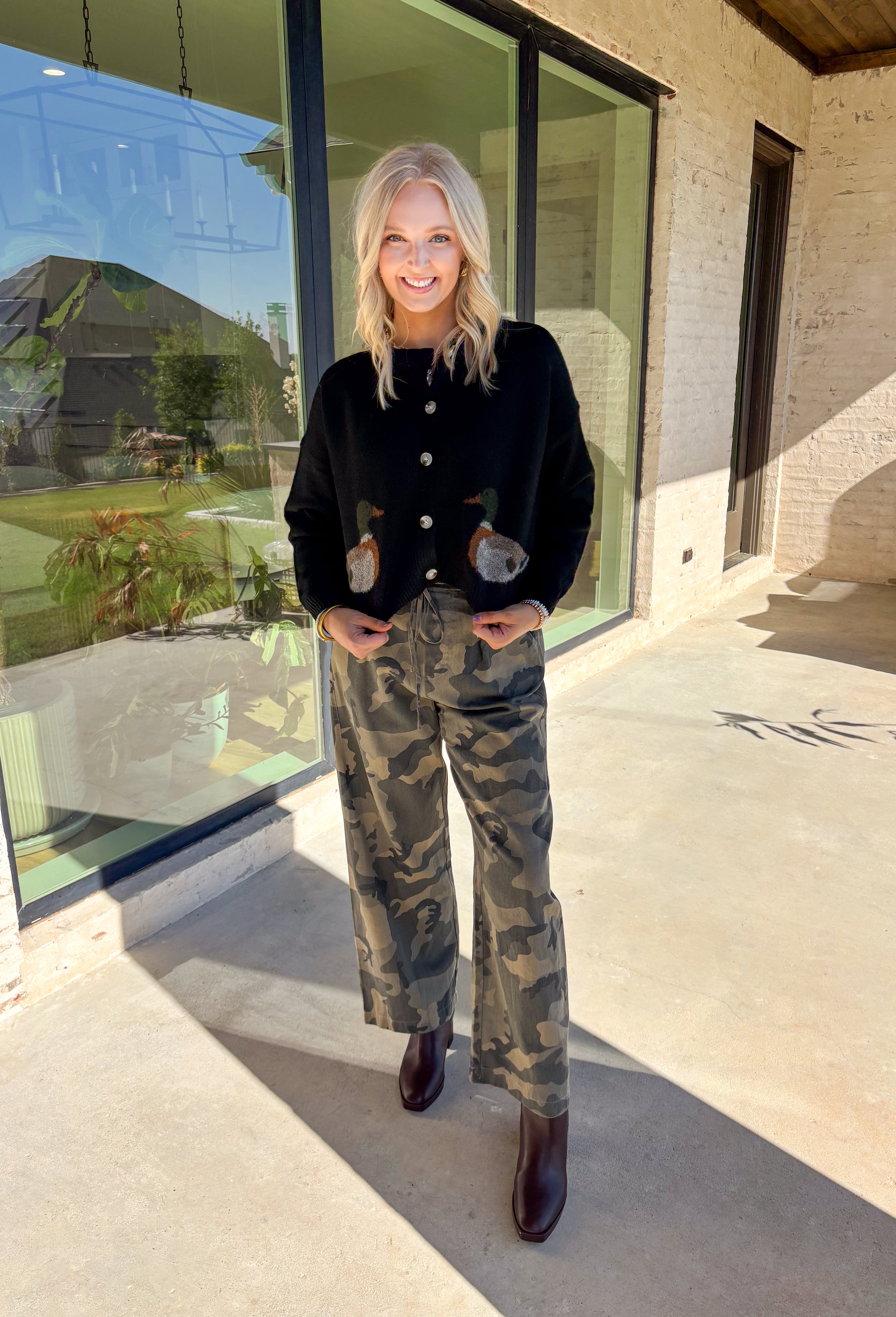 A cardigan with character—this black knit sweater is anything but ordinary. Designed with a button-down front, it’s accented with two charming ducks on the front that bring a whimsical, playful twist to your fall wardrobe. The soft knit blend offers warmth and comfort, while the relaxed fit makes it perfect for layering over everything from tees to dresses. A fun conversation starter that still feels cozy enough for everyday wear.