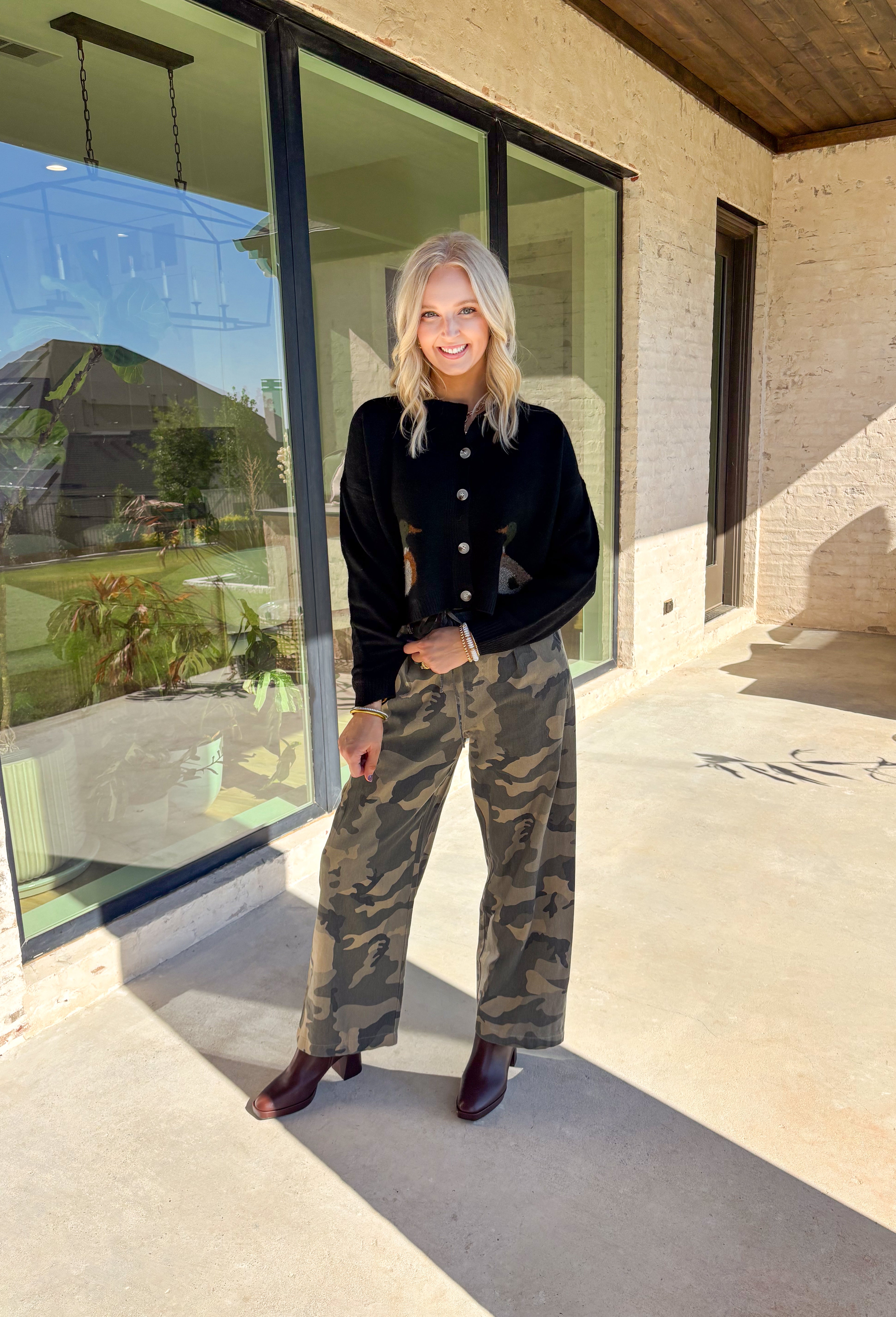 A cardigan with character—this black knit sweater is anything but ordinary. Designed with a button-down front, it’s accented with two charming ducks on the front that bring a whimsical, playful twist to your fall wardrobe. The soft knit blend offers warmth and comfort, while the relaxed fit makes it perfect for layering over everything from tees to dresses. A fun conversation starter that still feels cozy enough for everyday wear.