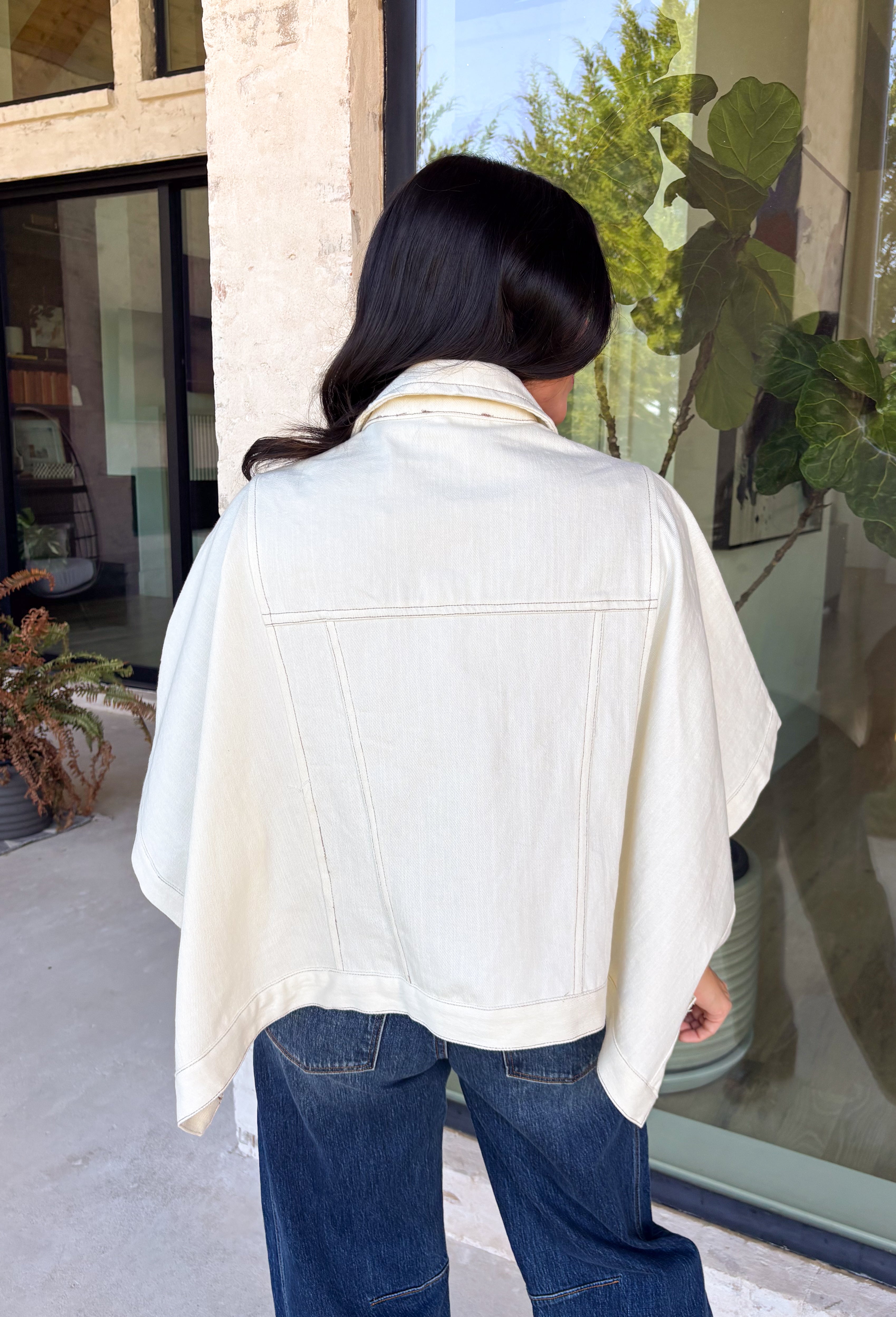 Meet the lightweight denim layer your wardrobe has been waiting for. This ecru short sleeve jacket from Entro gives classic denim a fresh update with a soft neutral shade and an easy draped silhouette. Snap buttons down the front keep the look casual, while chest pockets and additional front pockets add plenty of functional detail. Snap button closures at the sides give the design an unexpected finishing touch and add to its relaxed shape. 