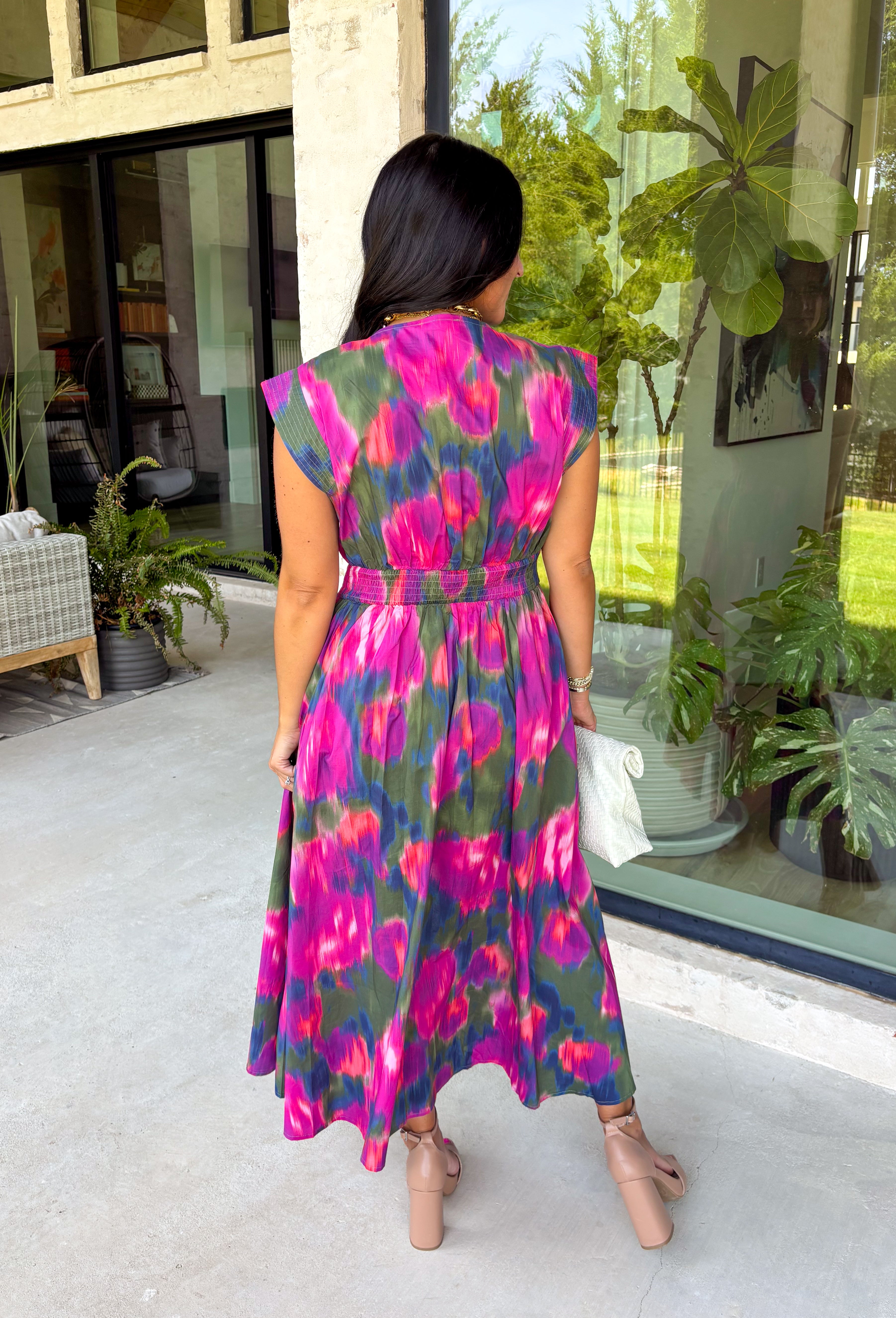 Bring a beautiful blend of color to your fall wardrobe with this eye-catching abstract print midi dress. Designed with a vibrant mix of autumn-inspired hues, this dress offers the perfect balance of playful style and timeless elegance. The flattering v-neckline is accented by a front zipper closure for a modern touch, while the defined waistband and smocked back waist create a comfortable, flattering fit. 