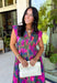 Bring a beautiful blend of color to your fall wardrobe with this eye-catching abstract print midi dress. Designed with a vibrant mix of autumn-inspired hues, this dress offers the perfect balance of playful style and timeless elegance. The flattering v-neckline is accented by a front zipper closure for a modern touch, while the defined waistband and smocked back waist create a comfortable, flattering fit. 