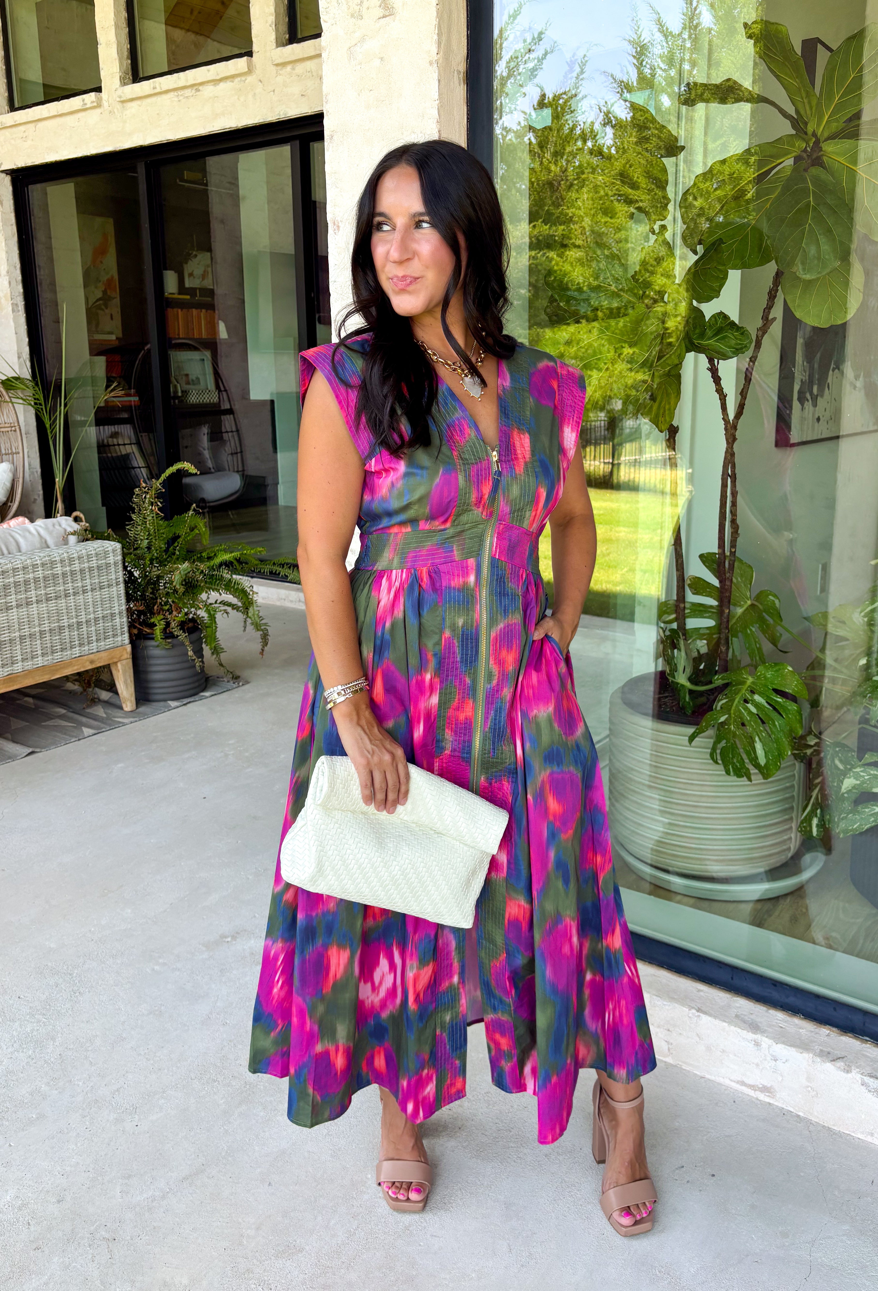 Bring a beautiful blend of color to your fall wardrobe with this eye-catching abstract print midi dress. Designed with a vibrant mix of autumn-inspired hues, this dress offers the perfect balance of playful style and timeless elegance. The flattering v-neckline is accented by a front zipper closure for a modern touch, while the defined waistband and smocked back waist create a comfortable, flattering fit. 