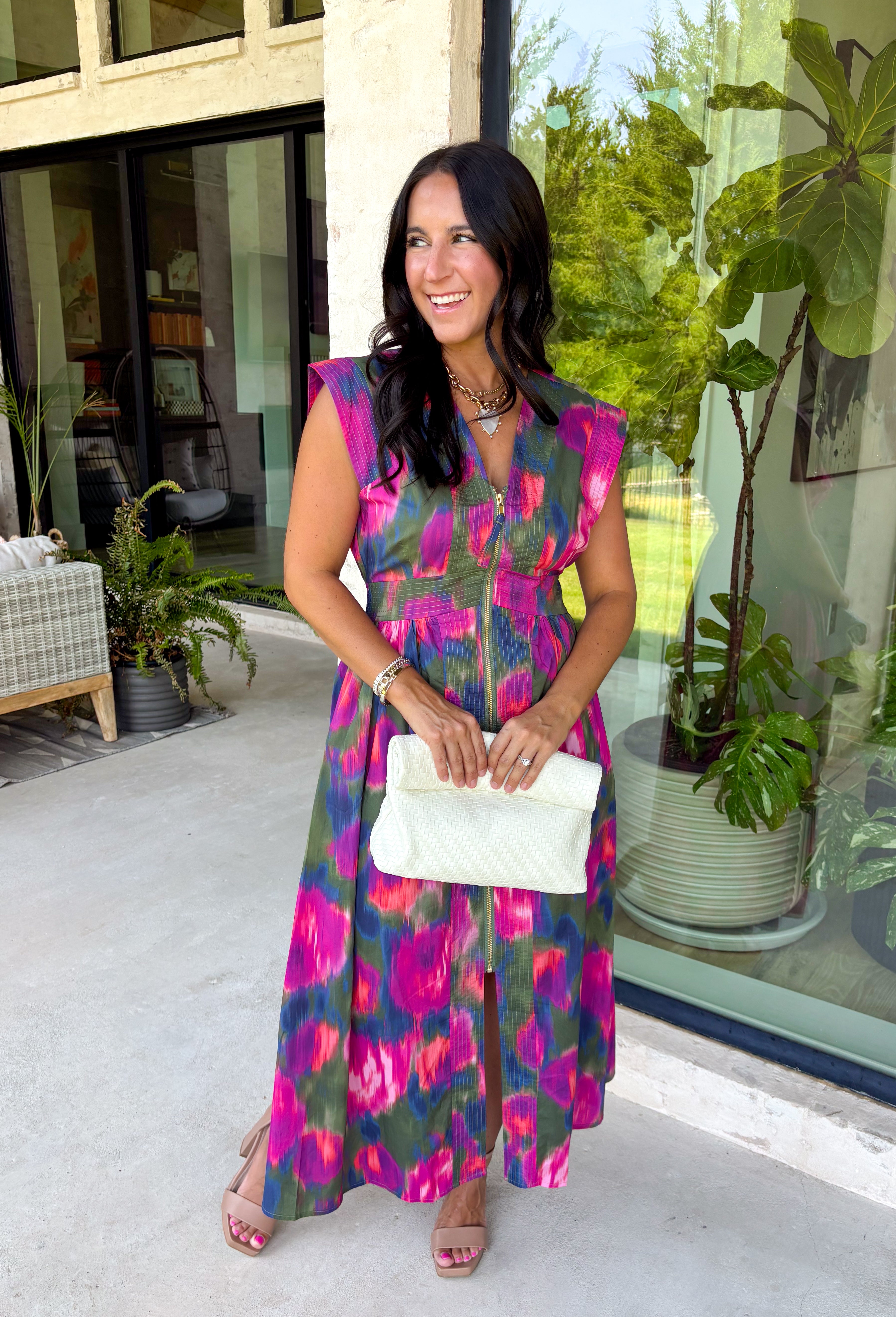 Bring a beautiful blend of color to your fall wardrobe with this eye-catching abstract print midi dress. Designed with a vibrant mix of autumn-inspired hues, this dress offers the perfect balance of playful style and timeless elegance. The flattering v-neckline is accented by a front zipper closure for a modern touch, while the defined waistband and smocked back waist create a comfortable, flattering fit. 